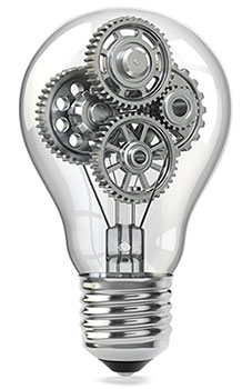 Light bulb with gears showing through the clear part of the bulb.
